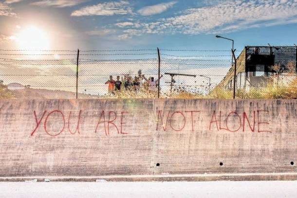 Unterstützer haben die Nachricht "Ihr seid nicht alleine" an der Mauer zum Asyllager in Kara Tepe hinterlassen.